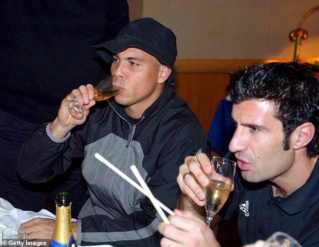 Ronaldo shares a glass of bubbly with fellow Galactico and ex-Barcelona man Luis Figo