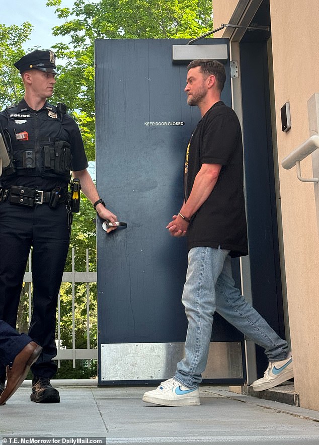 A bleary-eyed Timberlake was seen emerging from the Hamptons police station in handcuffs