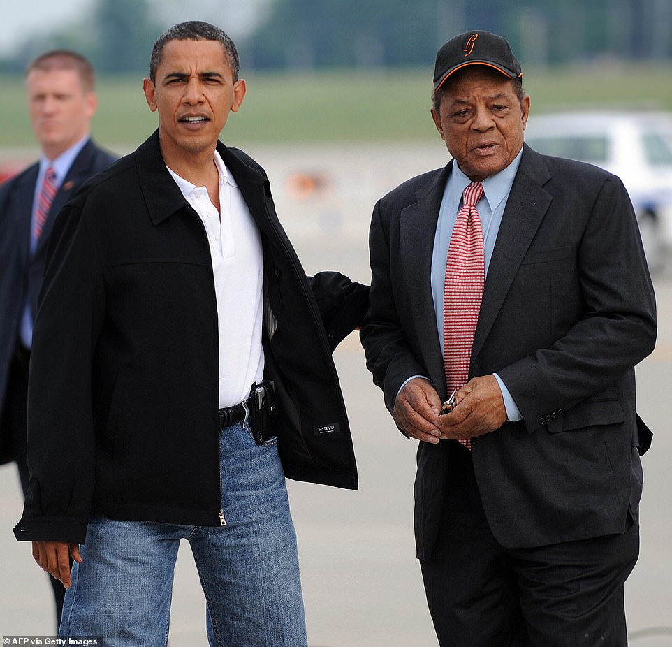 President Barack Obama (L) escorts Major League Baseball Hall of Famer Willie Mays (R) to the All-Star game on July 14, 2009