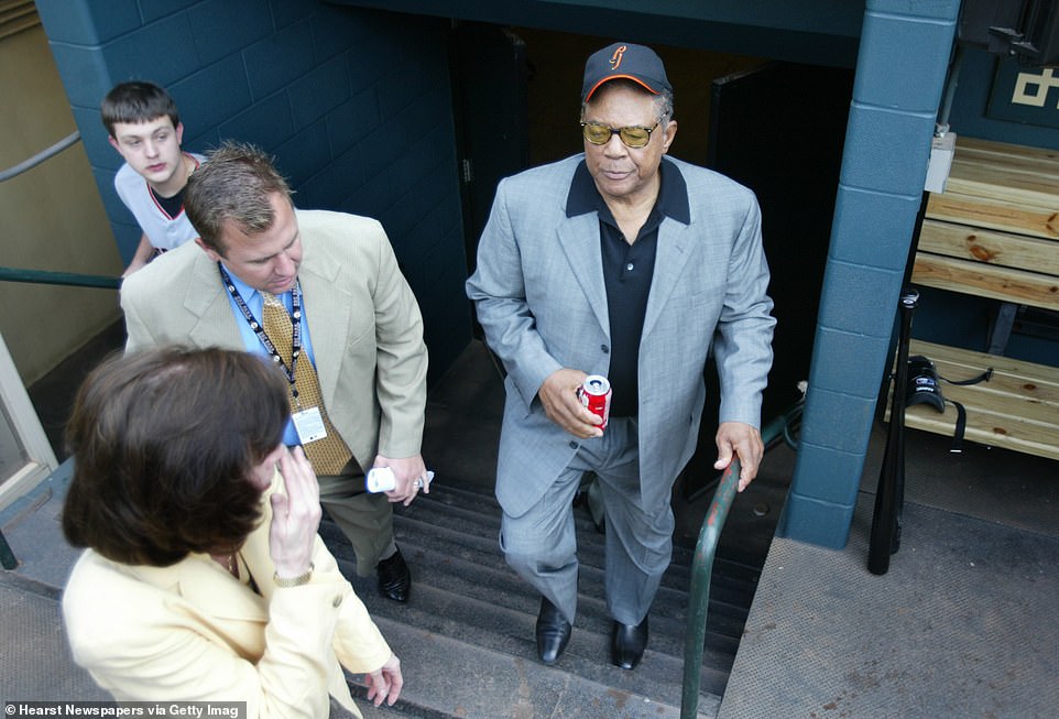 Willie Mays walks out into the Giants dugout before a game where his godson, Barry Bonds, was scheduled to play