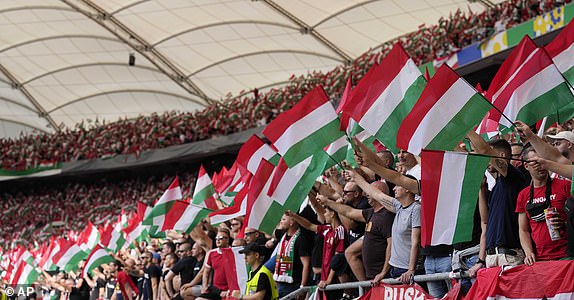 Hungary fans wave flags prior to the start of a Group A match between Germany and Hungary at the Euro 2024 soccer tournament in Stuttgart, Germany, Wednesday, June 19, 2024. (AP Photo/Antonio Calanni)