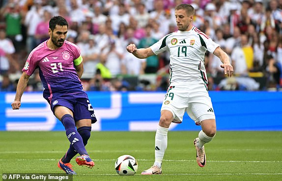 Germany's midfielder #21 Ilkay Gundogan ()L fights for the ball with Hungary's forward #19 Barnabas Varga  during the UEFA Euro 2024 Group A football match between Germany and Hungary at the Stuttgart Arena in Stuttgart on June 19, 2024. (Photo by DAMIEN MEYER / AFP) (Photo by DAMIEN MEYER/AFP via Getty Images)