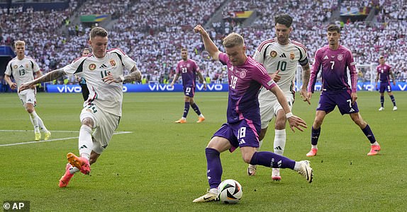 Germany's Maximilian Mittelstadt (18) crosses he ball past Hungary's Milos Kerkez (11) during a Group A match between Germany and Hungary at the Euro 2024 soccer tournament in Stuttgart, Germany, Wednesday, June 19, 2024. (AP Photo/Darko Vojinovic)