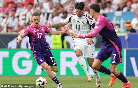 Germany's midfielder #17 Florian Wirtz fights for the ball with Hungary's midfielder #10 Dominik Szoboszlai during the UEFA Euro 2024 Group A football match between Germany and Hungary at the Stuttgart Arena in Stuttgart on June 19, 2024. (Photo by LLUIS GENE / AFP) (Photo by LLUIS GENE/AFP via Getty Images)