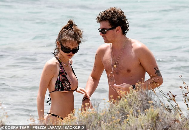 The rising model, 20, looked incredible as she frolicked along the beach in her skimpy two-piece during a day at the beach with her boyfriend Aris Rachevsky, her mother, stepfather Tom Kaulitz