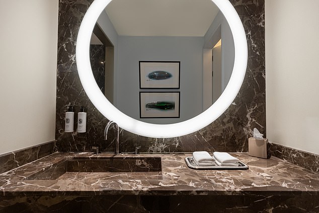 The marble-lined interior of the bathroom, which is stocked with Acqua di Parma products