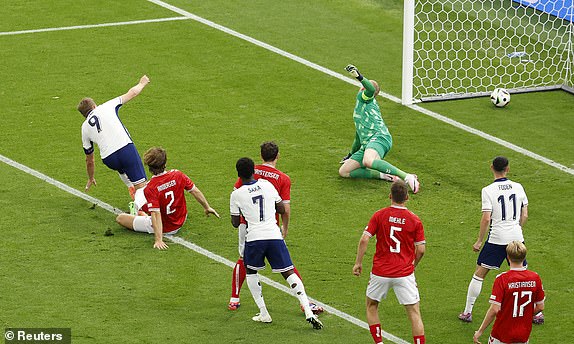 Soccer Football - Euro 2024 - Group C - Denmark v England - Frankfurt Arena, Frankfurt, Germany - June 20, 2024 England's Harry Kane scores their first goal past Denmark's Kasper Schmeichel REUTERS/Heiko Becker