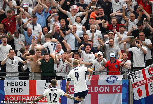 England fans at the packed Frankfurt Arena celebrate wildly in front of Harry Kane