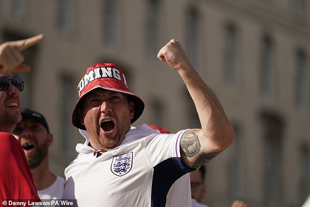 An England fans with an It's Coming Home bucket hat celebrates England's opener