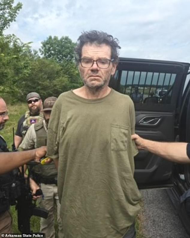Police released a photograph of Stacy Lee Drake grimacing with his eyes fixed on the ground while wearing a baggy khaki t-shirt and glasses as cops led him away in handcuffs. The multiple murder suspect was caught Thursday morning after two days on the run