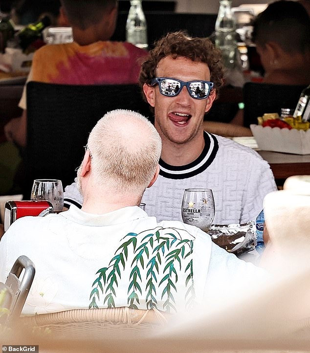 Pictured: Zuckerberg at lunch with friends in Ibiza, Spain