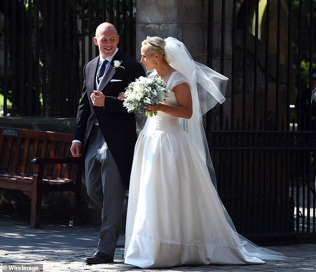 Zara and Mike walk arm in arm out of Canongate Kirk after their wedding, July 30, 2011