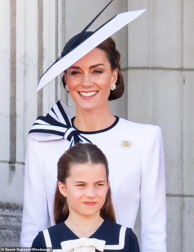 The Princess of Wales beams as she and her daughter Princess Charlotte are pictured on the balcony of Buckingham Palace during the flypast at last weekend's Trooping the Colour