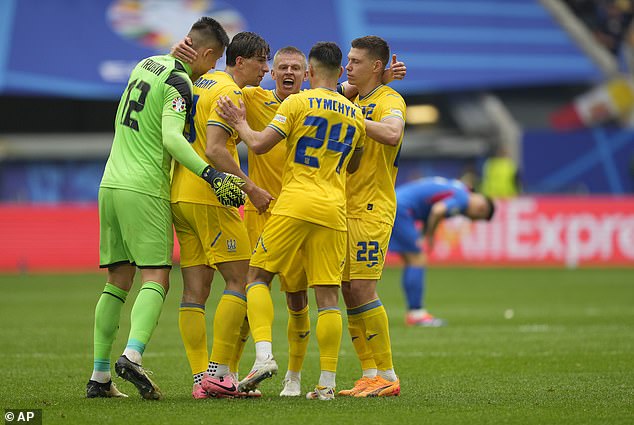 The players gathered in a huddle as they celebrated the win that kept their hopes of qualification alive