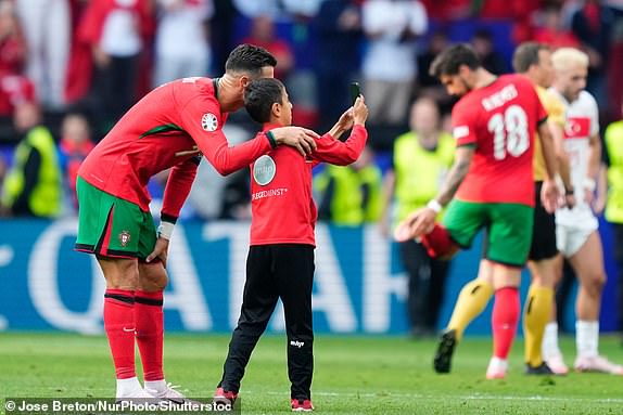 RESTRICTED TO EDITORIAL USE Mandatory Credit: Photo by Jose Breton/NurPhoto/Shutterstock (14553241aj) Pitch invader boy with Cristiano Ronaldo centre-forward of Portugal and Al-Nassr FC during the UEFA EURO 2024 group stage match between Turkiye and Portugal at Football Stadium Dortmund on June 22, 2024 in Dortmund, Germany. Turkiye v Portugal: Group F - UEFA EURO 2024, Dortmund, Germany - 22 Jun 2024