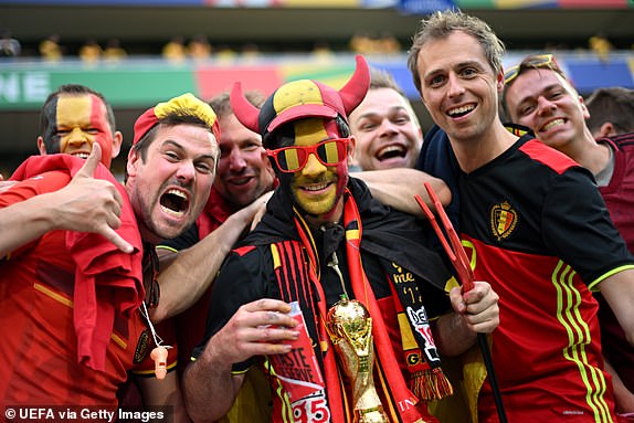 COLOGNE, GERMANY - JUNE 22: Fans of Belgium pose for a photo prior to the UEFA EURO 2024 group stage match between Belgium and Romania at Cologne Stadium on June 22, 2024 in Cologne, Germany. (Photo by Harriet Lander - UEFA/UEFA via Getty Images)