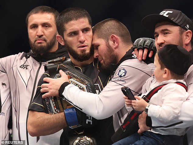 Islam Makhachev, centre, is embraced by Khabib Nurmagomedov after winning the UFC Lightweight Championship in October 2022. One of the shooters in the attacks in Dagestan is believed to have been a teammate of both Nurmagomedov and Makhachev