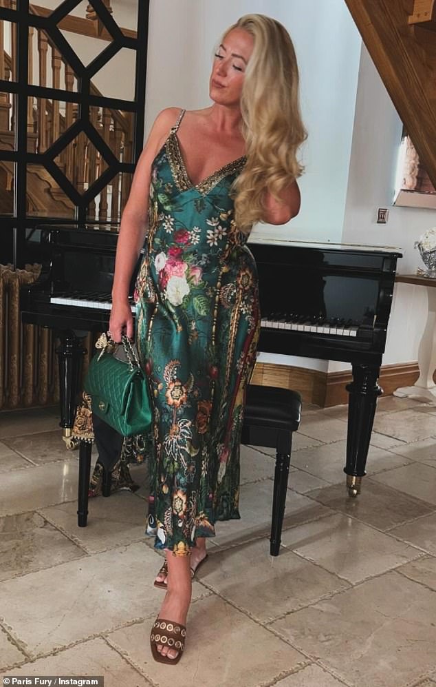 While Tyson opted for a polo shirt and shorts, Paris stunned in a plunging green floral dress and long with a quilted Chanel bag which costs an whopping £7K