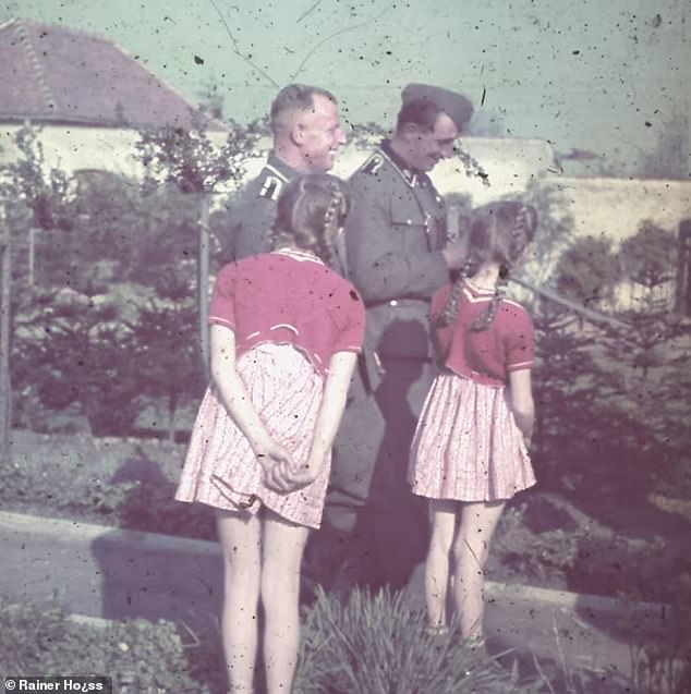 Daughters Brigitte and Heidetraud Höss are seen with soldiers in Auschwitz