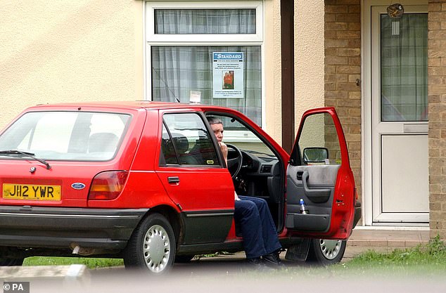 Huntley got new tyres put on his old Ford Fiesta car, which aroused suspicion and led to police investigating the vehicle. He is pictured sitting in his car outside his home on August 8, 2002
