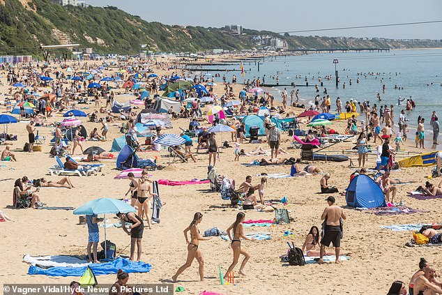 Hundreds flock to the beach in Bournemouth on Tuesday to make the most of the heat