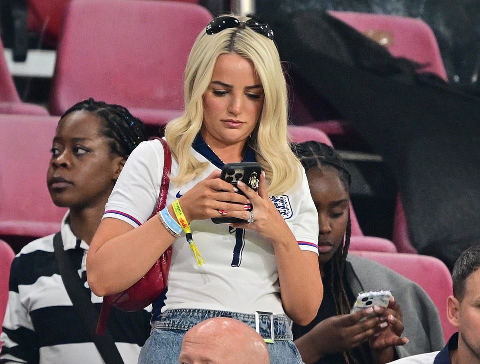 During the game, goalie Jordan Pickford's wife Meghan was seen reading her phone, as well as Wilkins' partner - while Bukayo Sako's girlfriend Tolami Benson stared up at the crowd above and treated herself to an ice cream mid-match.