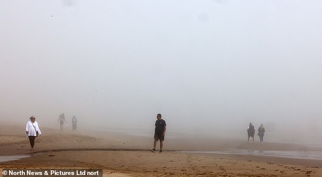 Thick fog engulfs beachgoers on Tynemouth Longsands beach in North Tyneside this morning