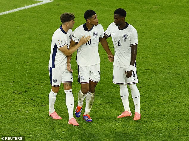 John Stones (left) and Marc Guehi (right) appear to try and calm Bellingham down