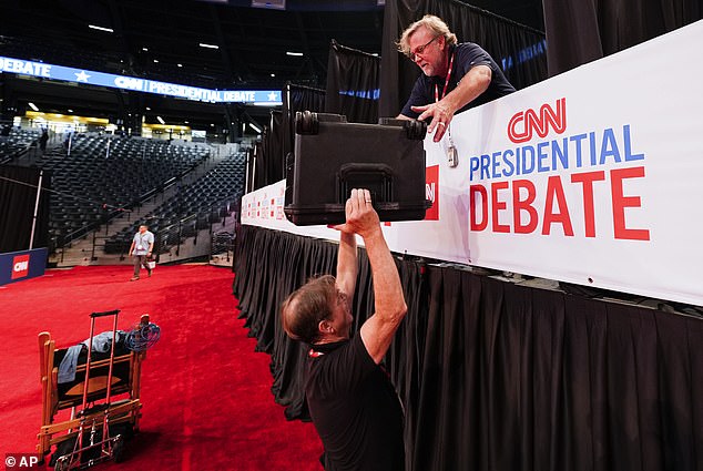 Bob Reilly, crew chief, and cameraman Chris Hanson, above, both of CSpan, setup for the upcoming CNN Presidential Debate