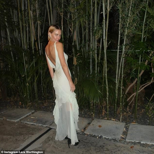 Lara Worthington flaunted her figure in a semi-sheer off-white dress as she posed for an impromptu photoshoot in Los Angeles