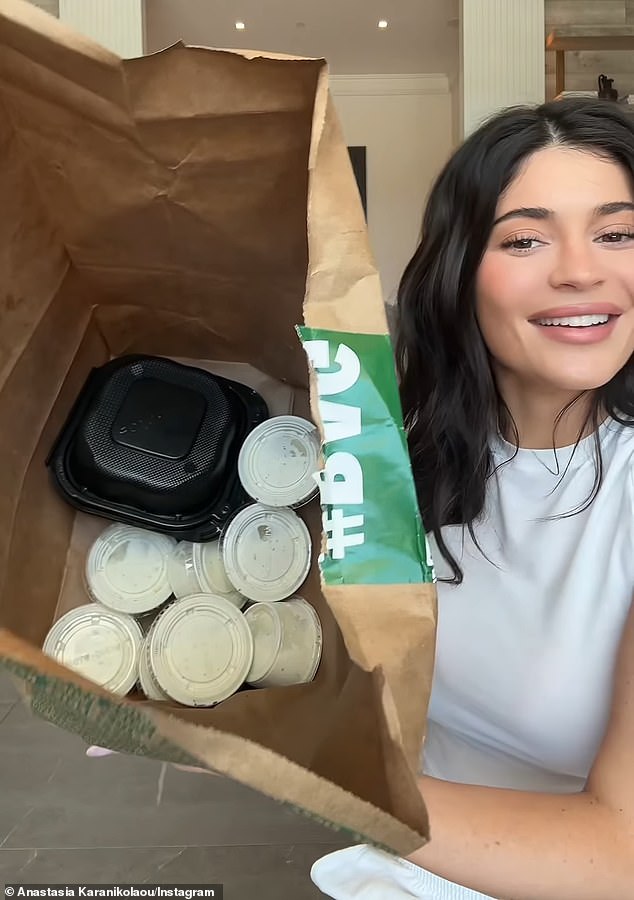 While her friend stepped away from the camera to grab extra napkins, the TV personality held up the bag to humorously show a multitude of ranch cups inside. 'Why did she get so much ranch?' she laughed