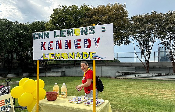 Supporters of Robert F. Kennedy Jr., stand at a lemonade stand near the presidential debate site before President Joe Biden and Republican presidential candidate former President Donald Trump debate in Atlanta, Thursday, June 27, 2024.(AP Photo/Steve Peoples)