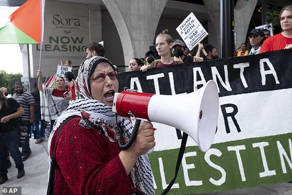 Jawahir Kamal leads pro-Palestinian protesters in a chant as they gather before a presidential debate between President Joe Biden and Republican presidential candidate former President Donald Trump in Atlanta, Thursday, June 27, 2024.Â (AP Photo/Ben Gray)