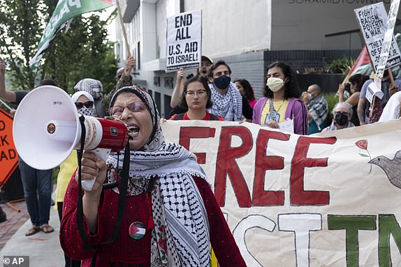 Jawahir Kamal leads pro-Palestinian protesters in a chant as they gather before a presidential debate between President Joe Biden and Republican presidential candidate former President Donald Trump in Atlanta, Thursday, June 27, 2024.Â (AP Photo/Ben Gray)