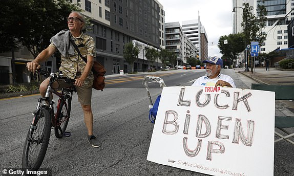 ATLANTA, GEORGIA - JUNE 27: Thomas Tulis (L) talks to Bob Kunst of Miami Beach, Florida, who's a supporter of Donald Trump for President on June 27, 2024 in Atlanta, Georgia. Supporters of President Joe Biden and former President Donald Trump will gather near the CNN campus where both candidates will have their first debate. (Photo by Octavio Jones/Getty Images)