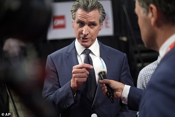 California Gov. Gavin Newsom speaks during an interview in the spin room before a presidential debate between President Joe Biden and Republican presidential candidate former President Donald Trump in Atlanta, Thursday, June 27, 2024. (AP Photo/Pablo Martinez Monsivais)