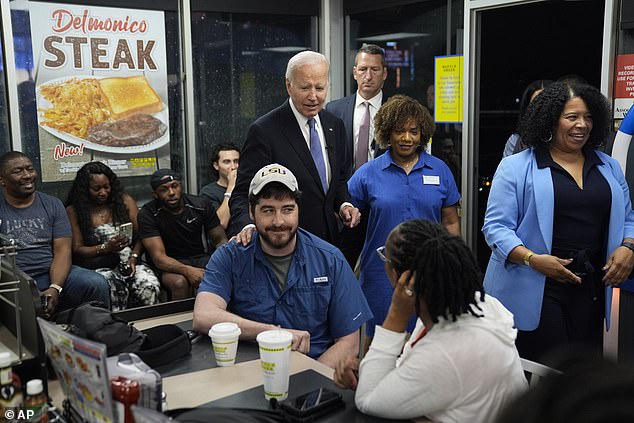 President Joe Biden pats a Waffle House customer as he makes a surprise stop after Thursday's debate at the favorite southern breakfast chain