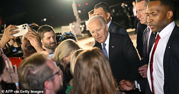 US President Joe Biden greets supporters gathered on the tarmac upon his arrival at Raleigh-Durham International Airport in Morrisville, North Carolina, early on June 28, 2024. (Photo by Mandel NGAN / AFP) (Photo by MANDEL NGAN/AFP via Getty Images)