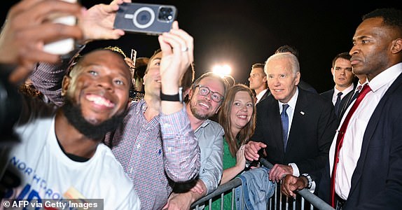 US President Joe Biden poses with supporters gathered on the tarmac upon his arrival at Raleigh-Durham International Airport in Morrisville, North Carolina, early on June 28, 2024. (Photo by Mandel NGAN / AFP) (Photo by MANDEL NGAN/AFP via Getty Images)