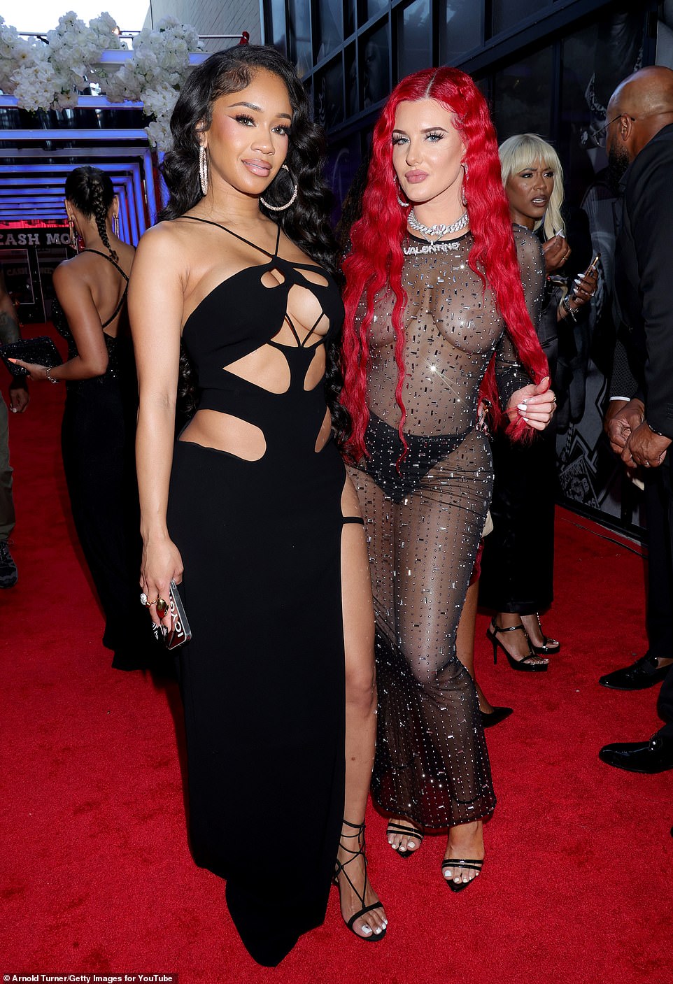 Saweetie (born Diamonté Harper) posed on the red carpet with Wild 'N Out star Justina Valentine (R), who made sure to wear nude pasties and Victoria's Secret panties beneath her embellished mesh dress