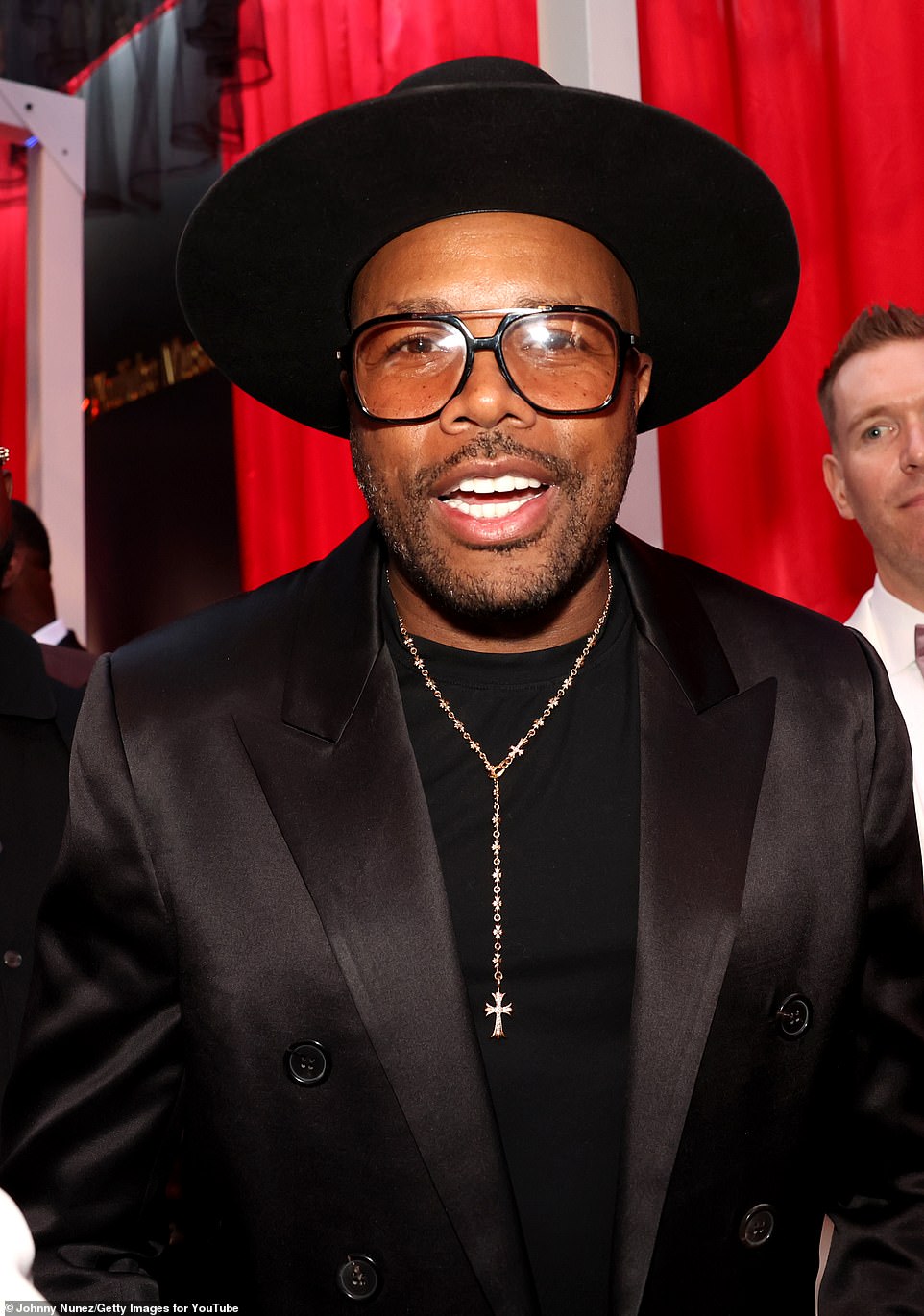 DJ D-Nice wore his favorite black wide-brimmed hat with his retro glasses and all-black suit