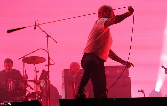 Talbot swings his microphone around on the Other Stage at Glastonbury