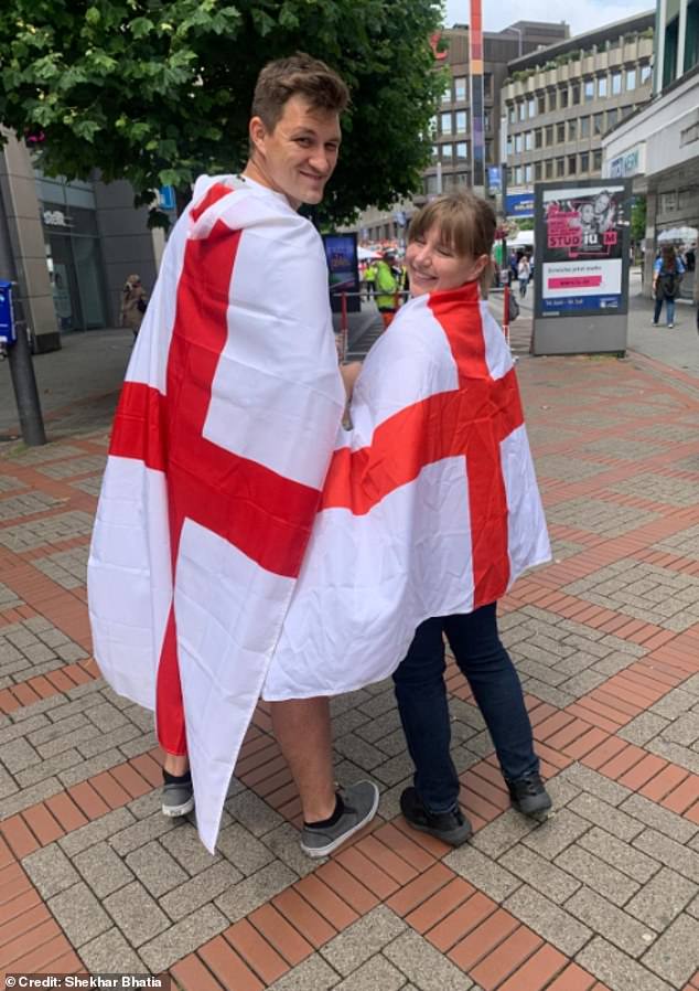 Two Slovenians also travelled to Gelsenkirchen to support England and had the flag of St George draped over their shoulders - Michael Mikla, 25, from Ljubljana, and his friend Anja