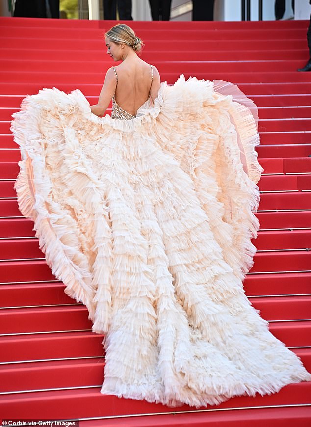 She stepped out in a sheer nude gown which featured intricate jewel detailings, which she paired with a dramatic cream layered tulle shawl which doubled as a train