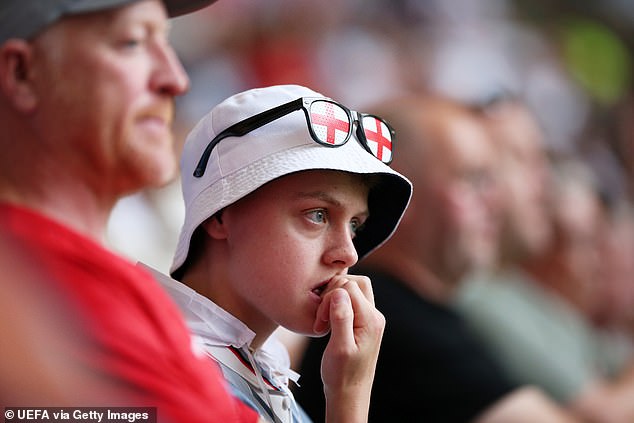 A fan inside the Arena AufSchalke was pictured worriedly hoping for England to fight back