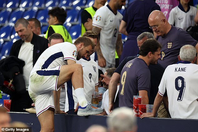 Captain Kane climbs over the boards after the game at the Arena AufSchalke