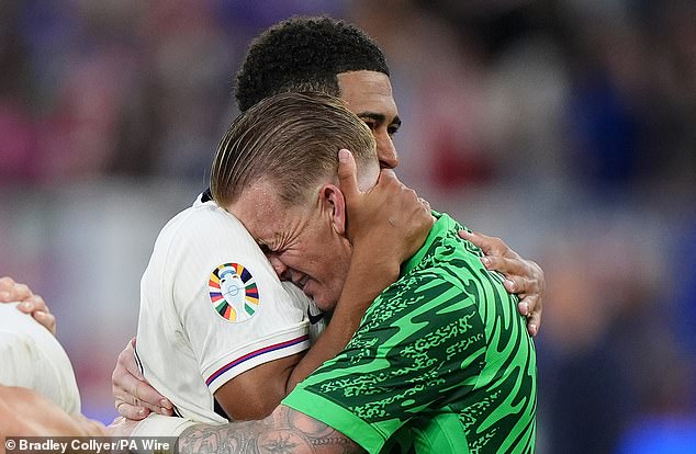 England goalkeeper Jordan Pickford gives Bellingham a warm embrace at the final whistle