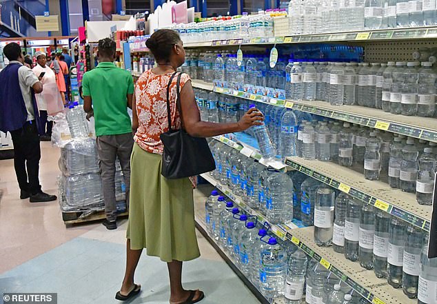 People shop for bottled water in a supermarket ahead of the arrival of Hurricane Beryl in Bridgetown, Barbados on June 30, 2024