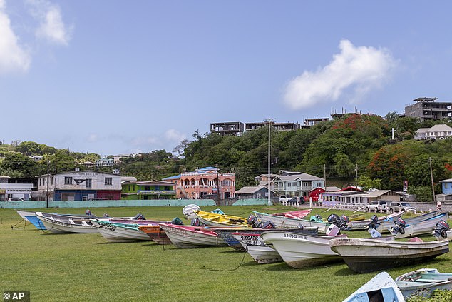 Fishing boats lie in a field after being moved to prevent potential damage ahead of the arrival of Hurricane Beryl in Calliaqua, St. Vincent and the Grenadines on Sunday, June 30, 2024