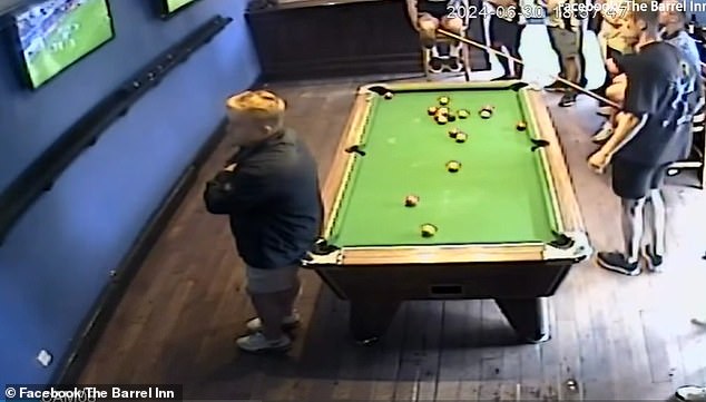 Video from one pub shows two men playing pool in front of a TV screen as others nervously watch on